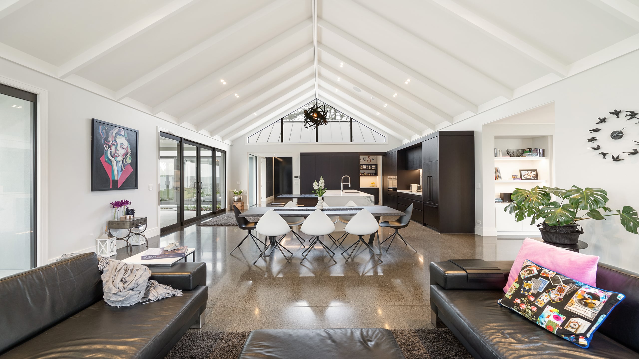 coloured concrete 673, polished concrete floors Open plan lounge dining and kitchen with polished coloured concrete floors and a decorative pattern.