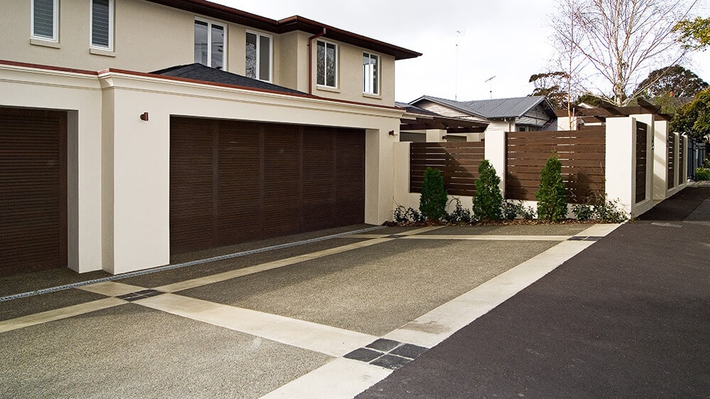 coloured-concrete-driveway-with-borders coloured concrete driveway with two colours and textures.