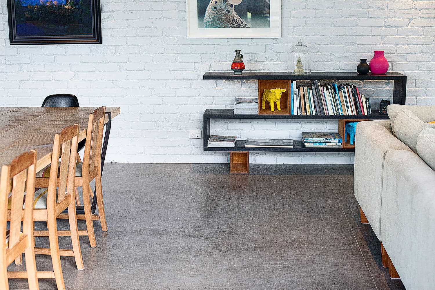 stylish coloured concrete floors and brick wall