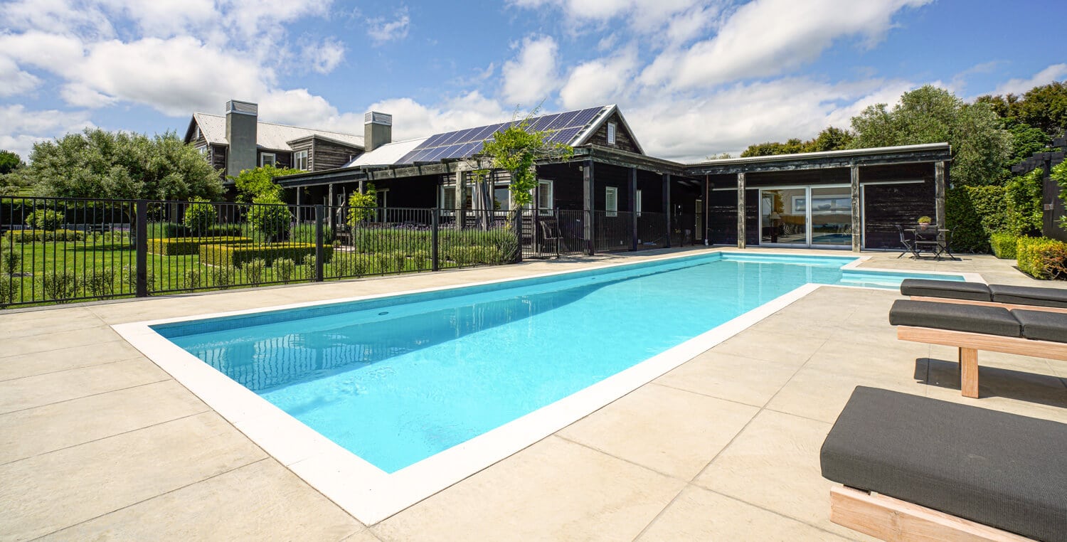 coloured concrete pool surround at amazing rural home.