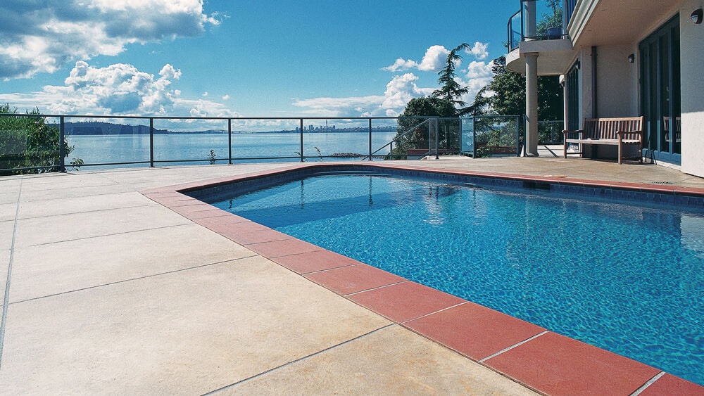 Coloured concrete around a pool in Auckland